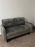 Grey two seater velvet sofa