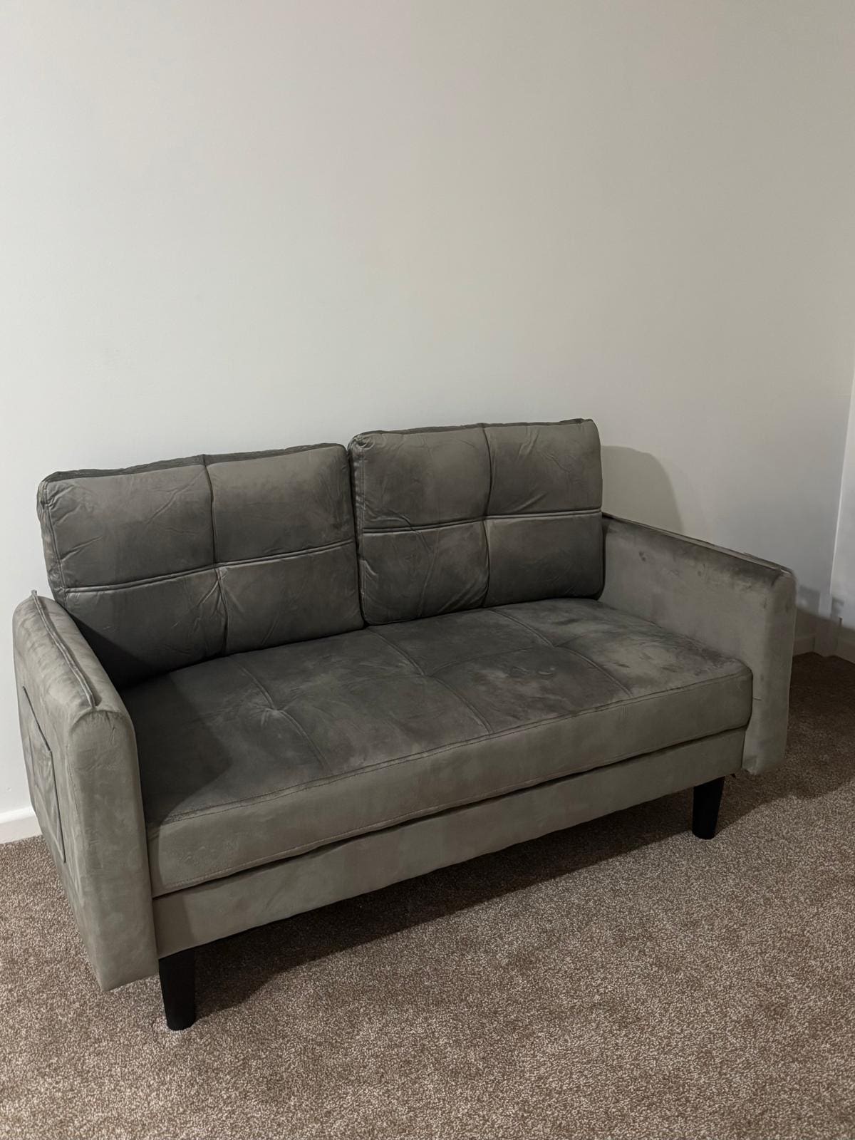 Grey two seater velvet sofa